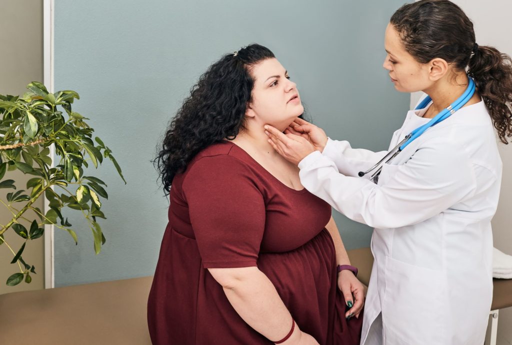 hypothyroidism fibroids doctor womans neck for diagnostics of thyroid