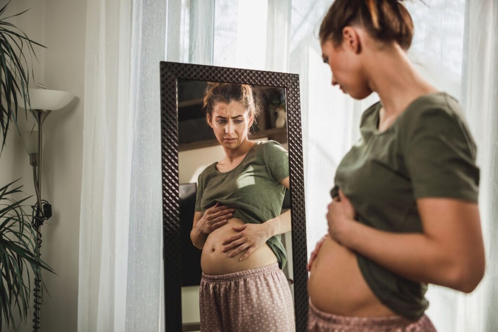 fibroids make your stomach look pregnant: woman with stomach bloating